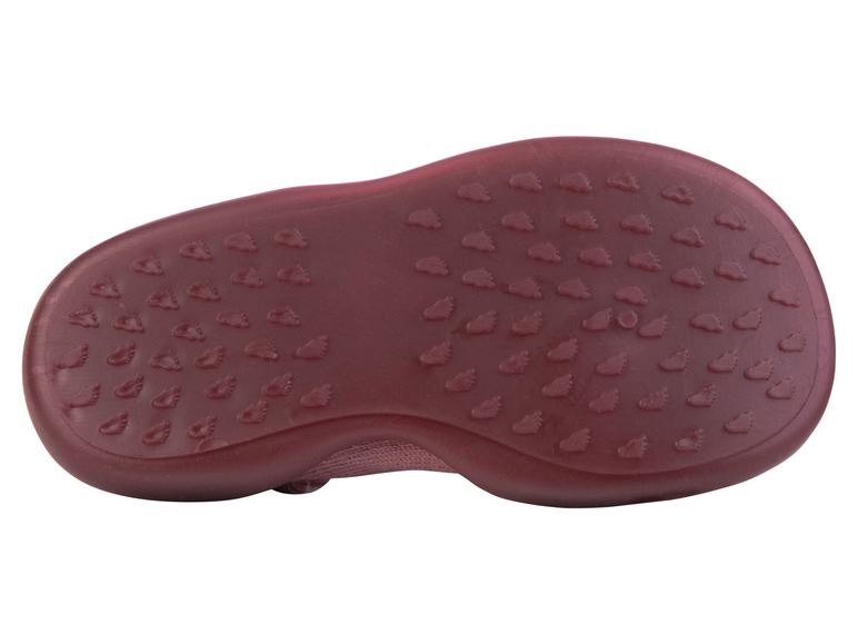 La semelle d'une sneaker rose avec un motif de petites empreintes de pieds.