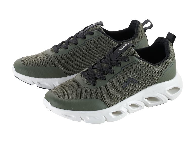 Een paar olijfgroene Crivit sportschoenen met een witte zool.