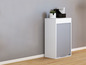 Une armoire blanche avec un volet roulant gris sur un sol en bois.