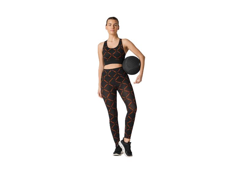Vrouw in zwarte CRIVIT sporttop en legging met medicijnbal.