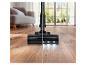 Aspirateur avec lumières sur parquet, plus sombre à gauche, plus clair à droite.