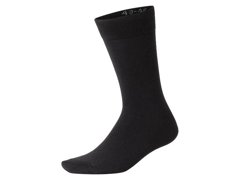 Chaussette noire unie avec des chiffres blancs visibles sur le revers.