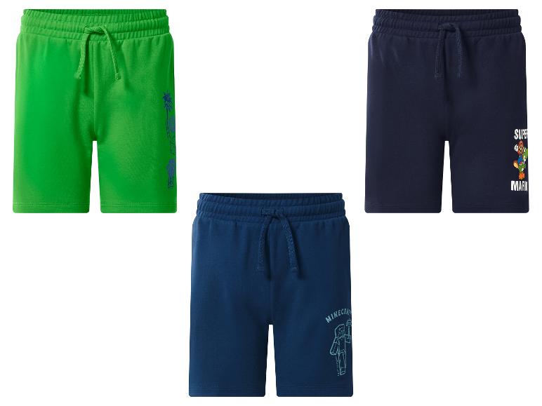 Drie kinderbroekjes: groen met palmboommotief, donkerblauw met Super Mario en donkerblauw met Minecraft.