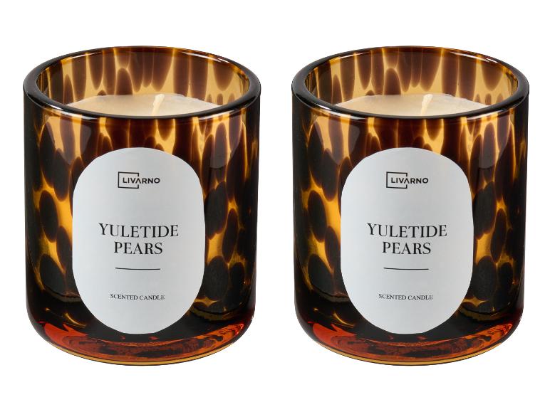 Twee Livarno Yuletide Pears geurkaarsen in bruine glazen houders.