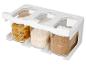 Wit rek met drie doorzichtige containers gevuld met pasta, rijst en bruine suiker.