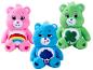 Trois peluches Bisounours : rose, bleue et verte, avec des insignes distinctifs sur le ventre.