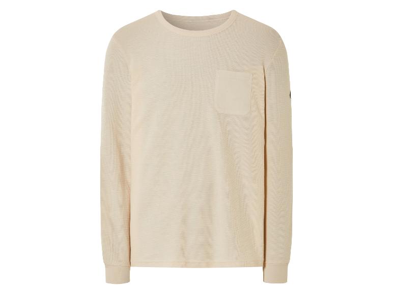 T-shirt à manches longues beige clair avec poche.