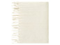 Une couverture en laine blanche avec des franges.