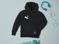 Een zwarte hoodie met skateboard print, blauwe koptelefoon en een skateboard.