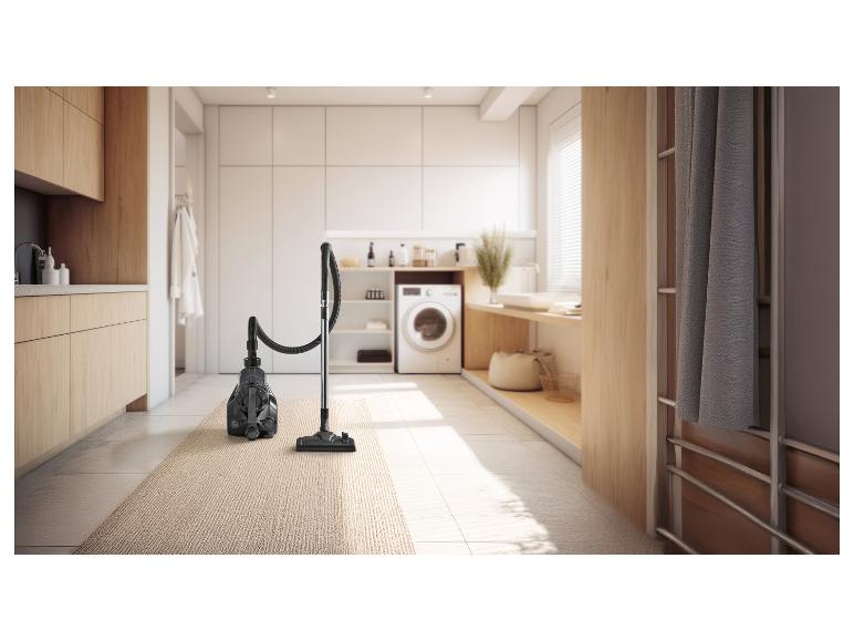 Stofzuiger op een vloerkleed in een moderne wasruimte.