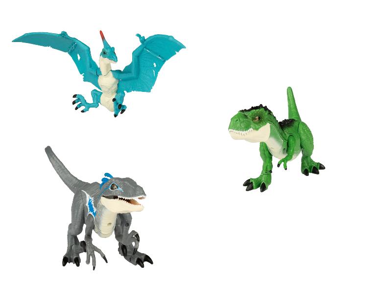 Trois jouets de dinosaures, dont un Pteranodon, un Tyrannosaurus Rex et un Blue.