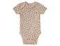 Un body bébé beige à pois bleus.