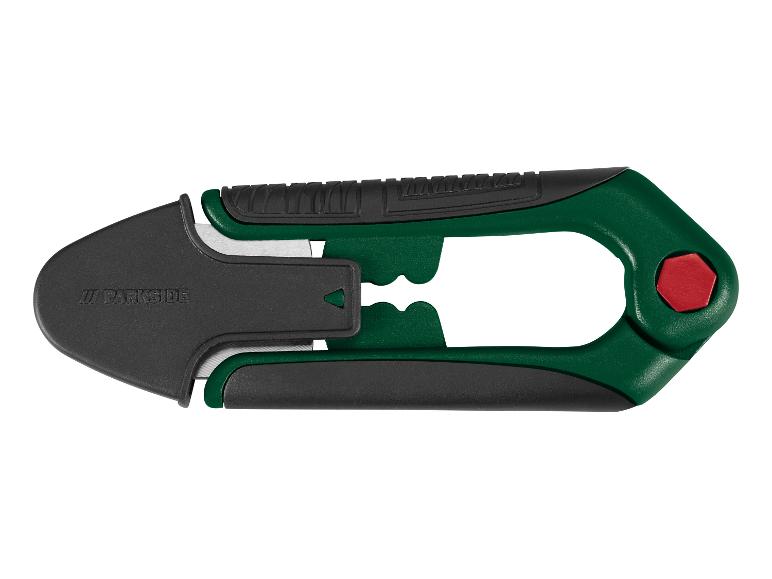 Couteau universel vert et noir avec lame rétractable et poignée ergonomique.