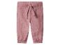 Pantalon en mousseline rose avec taille élastique et cordon de serrage.