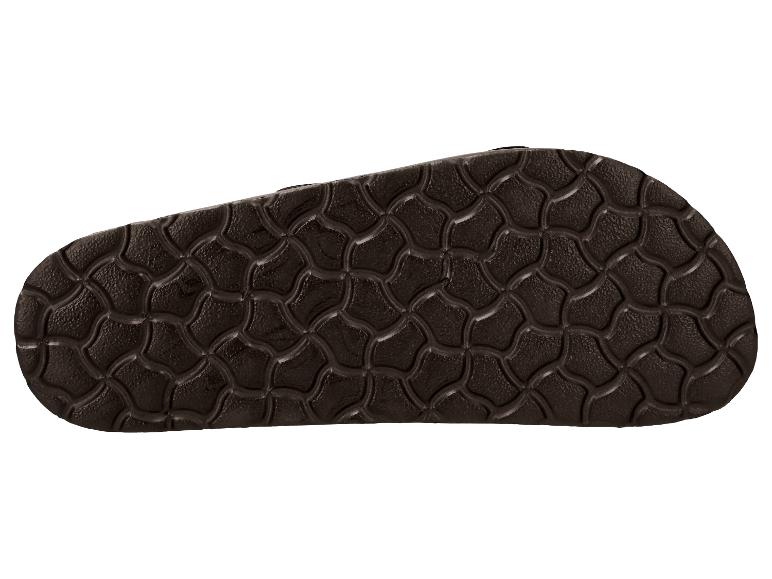 Semelle de sandale marron avec motif de grille ondulée.