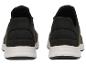 Vues arrière de baskets de sport noires et kaki avec semelle blanche.