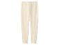 Pantalon de jogging beige clair avec taille élastique et chevilles resserrées.