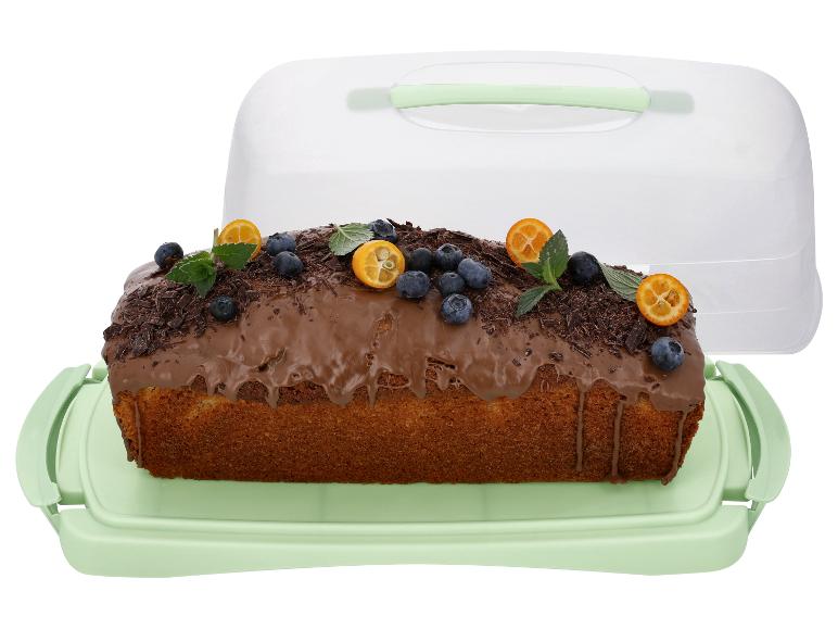 Cake met chocoladeglazuur, bosbessen en kumquat in een groene bewaardoos