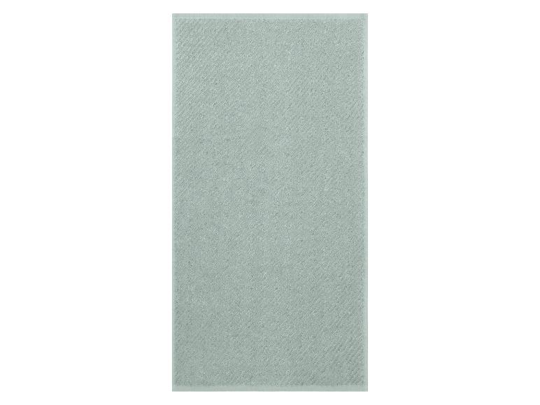 Lichtgroene katoenen handdoek met een diagonaal gestreept patroon