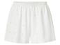 Shorts blancs femme avec broderie anglaise et taille élastiquée.