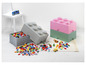 LEGO-opbergdozen in grijze, roze en groene kleur met LEGO-stenen eromheen.