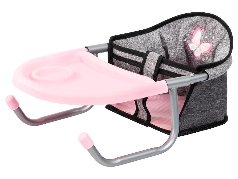 Une chaise rose avec une table pour poupées.