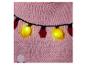 Roze gebreide trui met gele lichtjes en rode kerstballen.