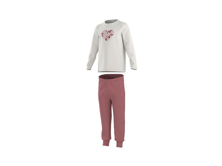 Pyjama blanc à manches longues avec cœurs et pantalon long rose foncé.