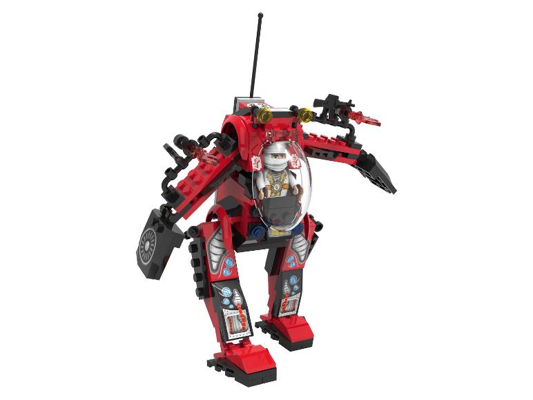 Een rood speelgoedrobot met een minifiguur in de cockpit.