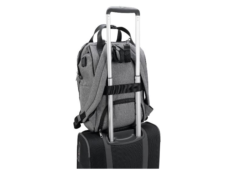 Un sac à dos gris attaché à une valise noire avec une poignée télescopique.