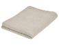 Beige katoenen deken, opgevouwen.