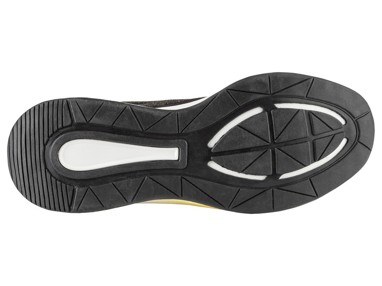 La semelle d'une chaussure de sport noire avec un accent blanc