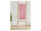 Serviette de bain s.Oliver à motif géométrique rose, suspendue à une échelle en bois.