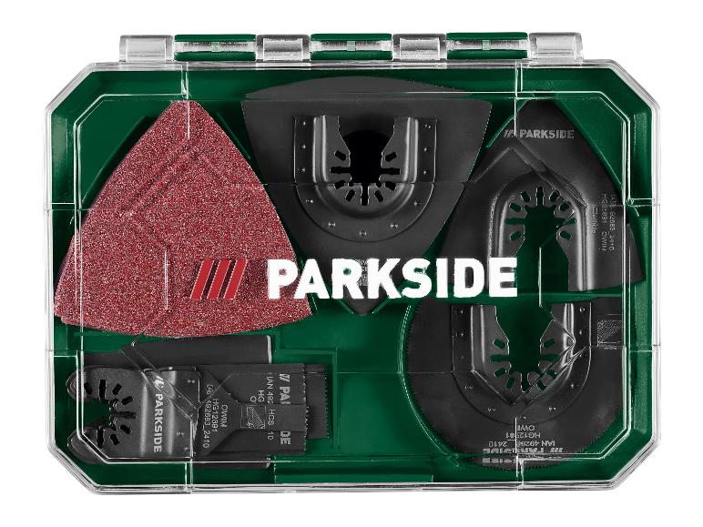 Multitool accessoire set met zaagbladen en schuurpapier in een groene koffer.