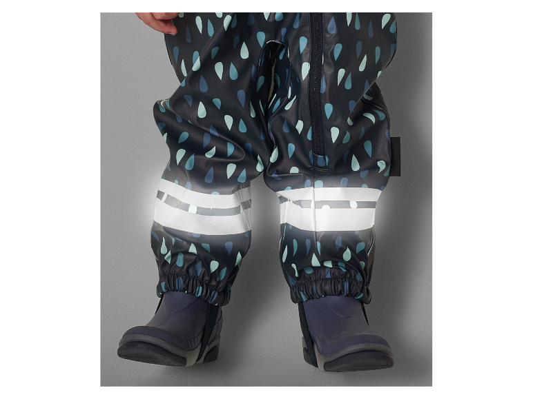 Waterdichte kinder overall met druppelprint en reflecterende details.