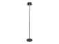 Lampadaire noir avec abat-jour plissé sur fond blanc.