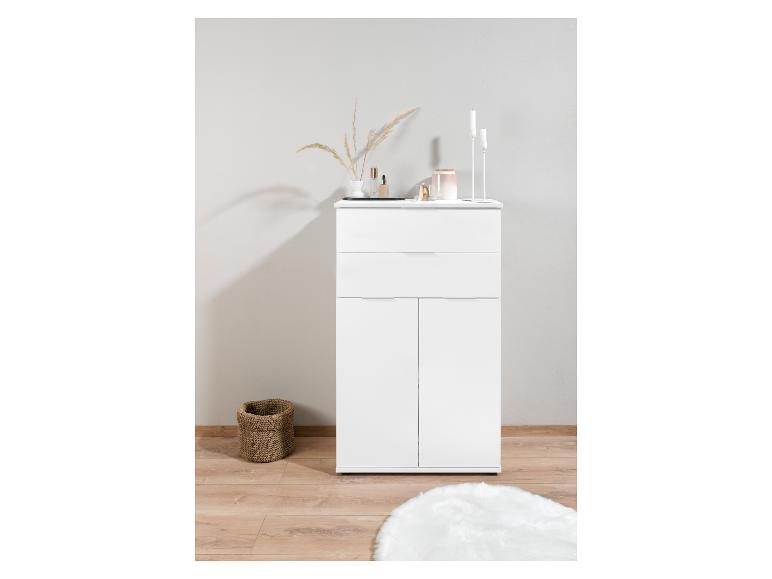 Armoire blanche avec deux portes et un tiroir, un panier et un tapis blanc.