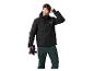 Man in zwarte ski-jas, groene broek en skibril.