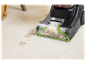 Nettoyeur de tapis Bissell PowerWash en action sur une moquette.
