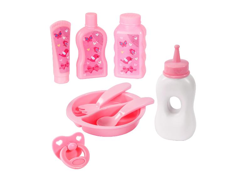 Roze poppenaccessoireset met fles, kom, bestek, speen en flessen.
