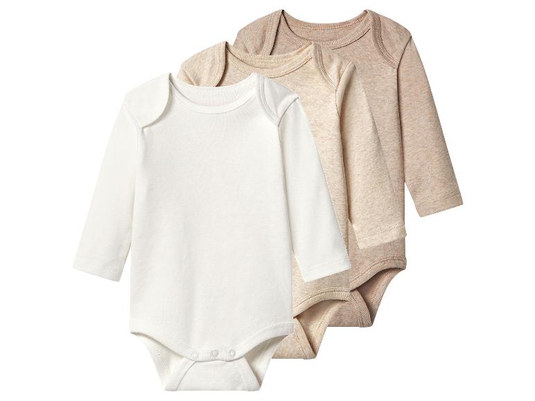 Drie beige en witte rompertjes met lange mouwen