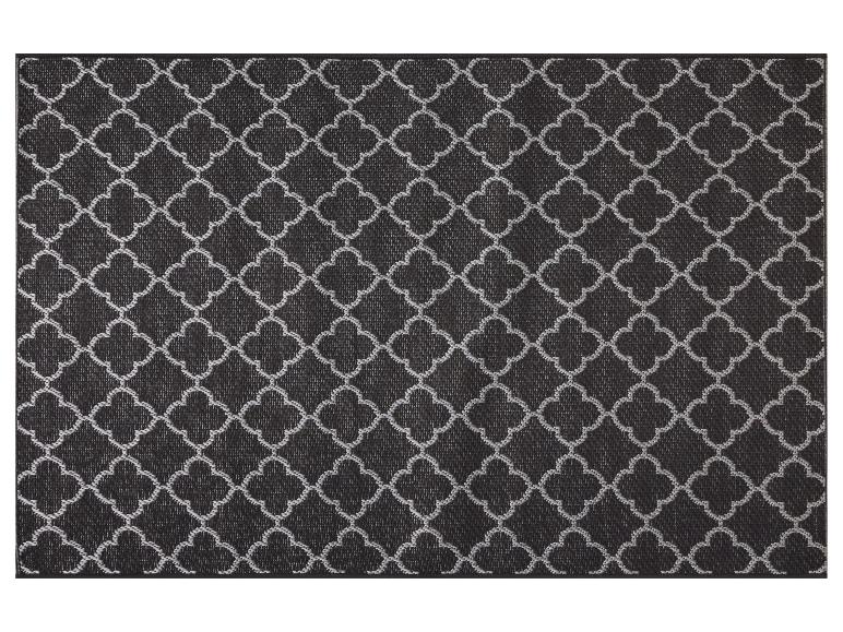 Tapis de sol avec motif géométrique de trèfle noir et blanc.