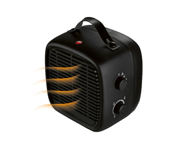 Zwarte kachel met handvat, met warme lucht die uit het rooster stroomt