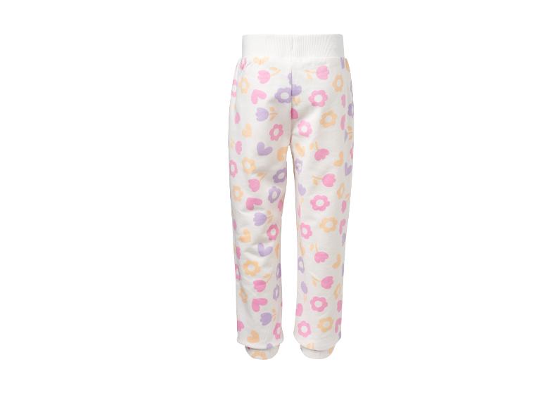 Witte kinderjoggingbroek met kleurrijke bloemen- en hartjespatronen.