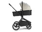 Een zwarte kinderwagen met een beige kap