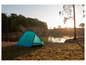 Een blauwe Grand Canyon tent op een kampeerplaats aan het water.