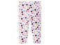 Witte legging met veelkleurige stippen en hoofden van stripfiguren.