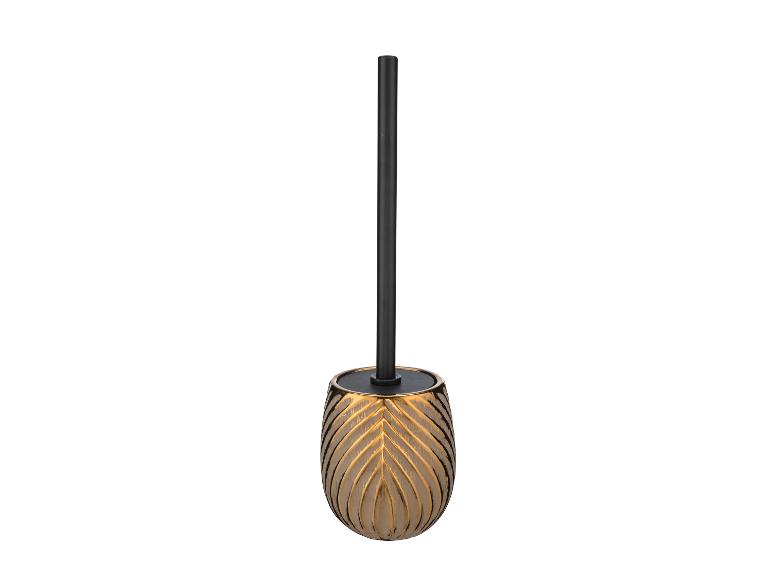 Brosse de toilette dorée avec manche noir.