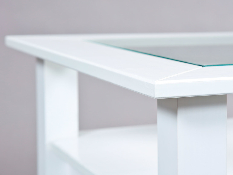 Witte salontafel met glazen blad.