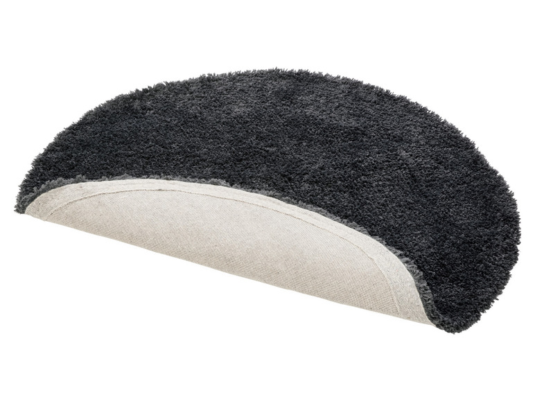 Een grijs rond vloerkleed met een beige rand.